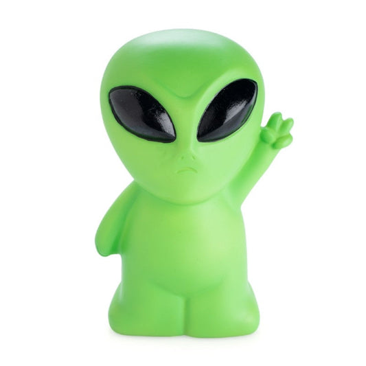 a green alien figurine with black eyes