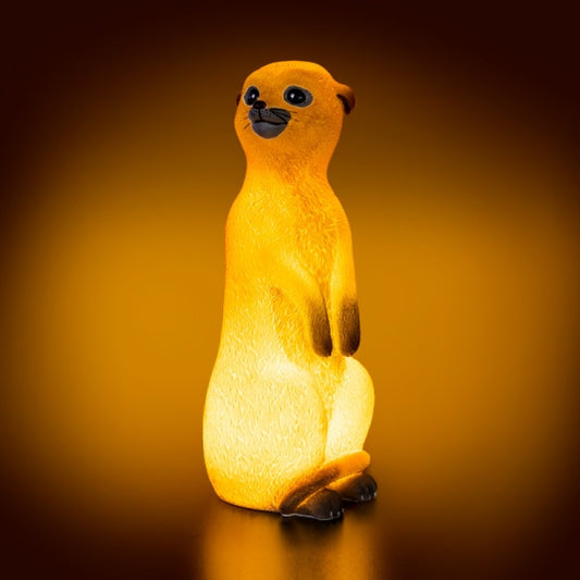 a small yellow meerkat lamp sitting on its hind legs