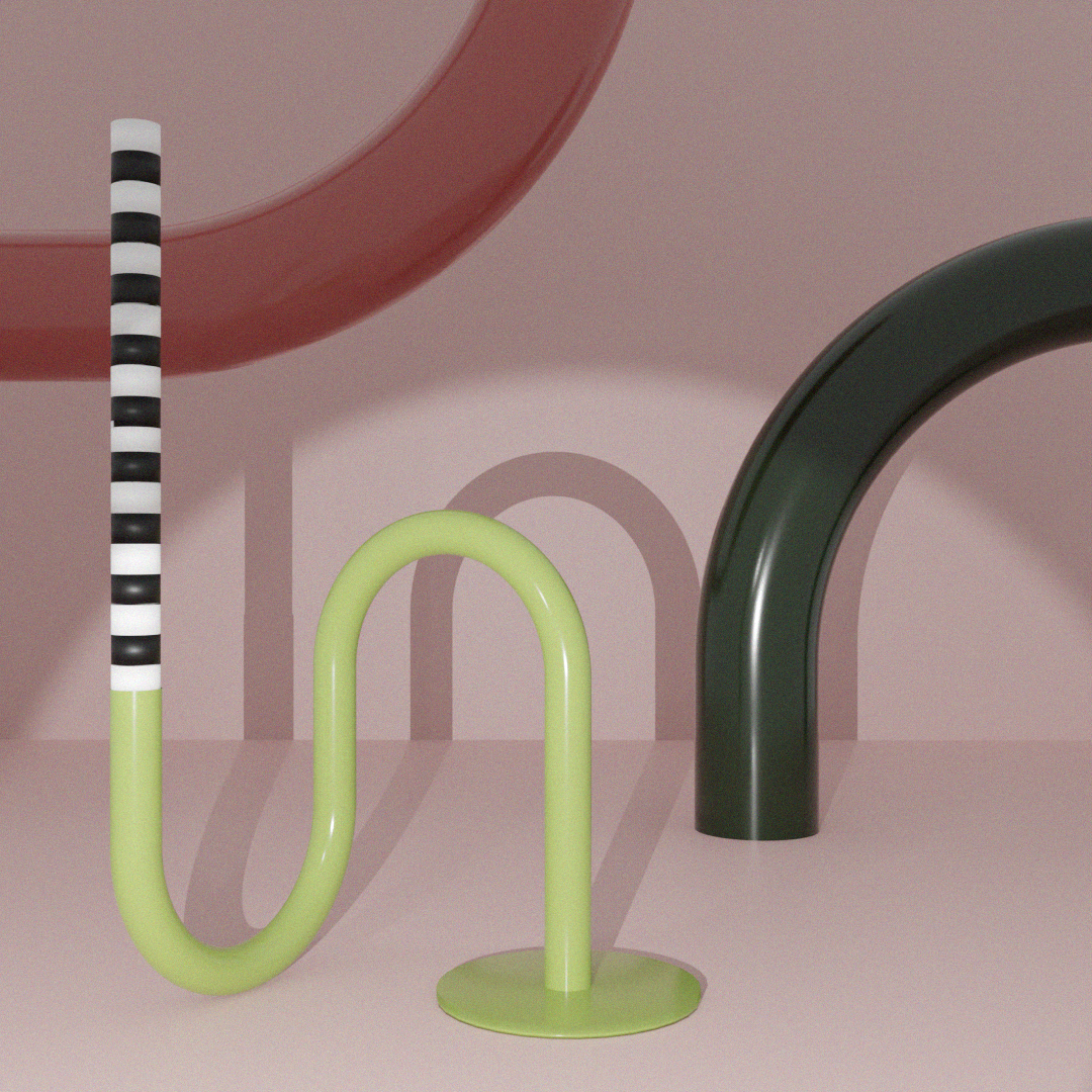 a pair of green and black handles next to a pink wall